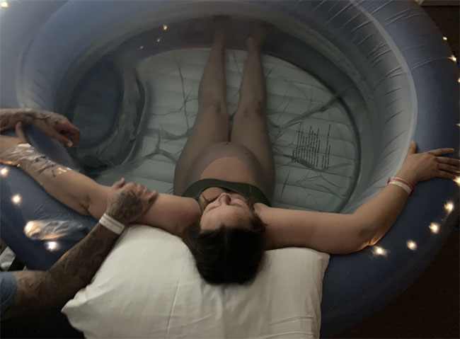 photo of a pregnant woman inside an inflatable pool about to give birth through hypnobirthing method